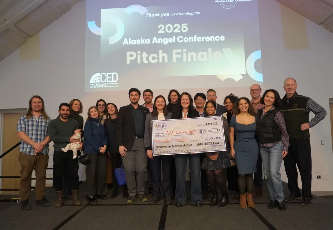 The 2025 winning startup, SWOOP, holding the $100,000 Alaska Angel Conference check with the cohort
